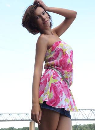 Suzanna A sensually poses outdoors as she strips her beautiful dress.